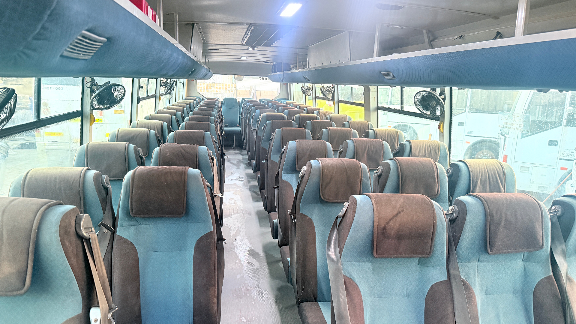 JMT-067 — full cabin, blue/brown high-back seats with belts